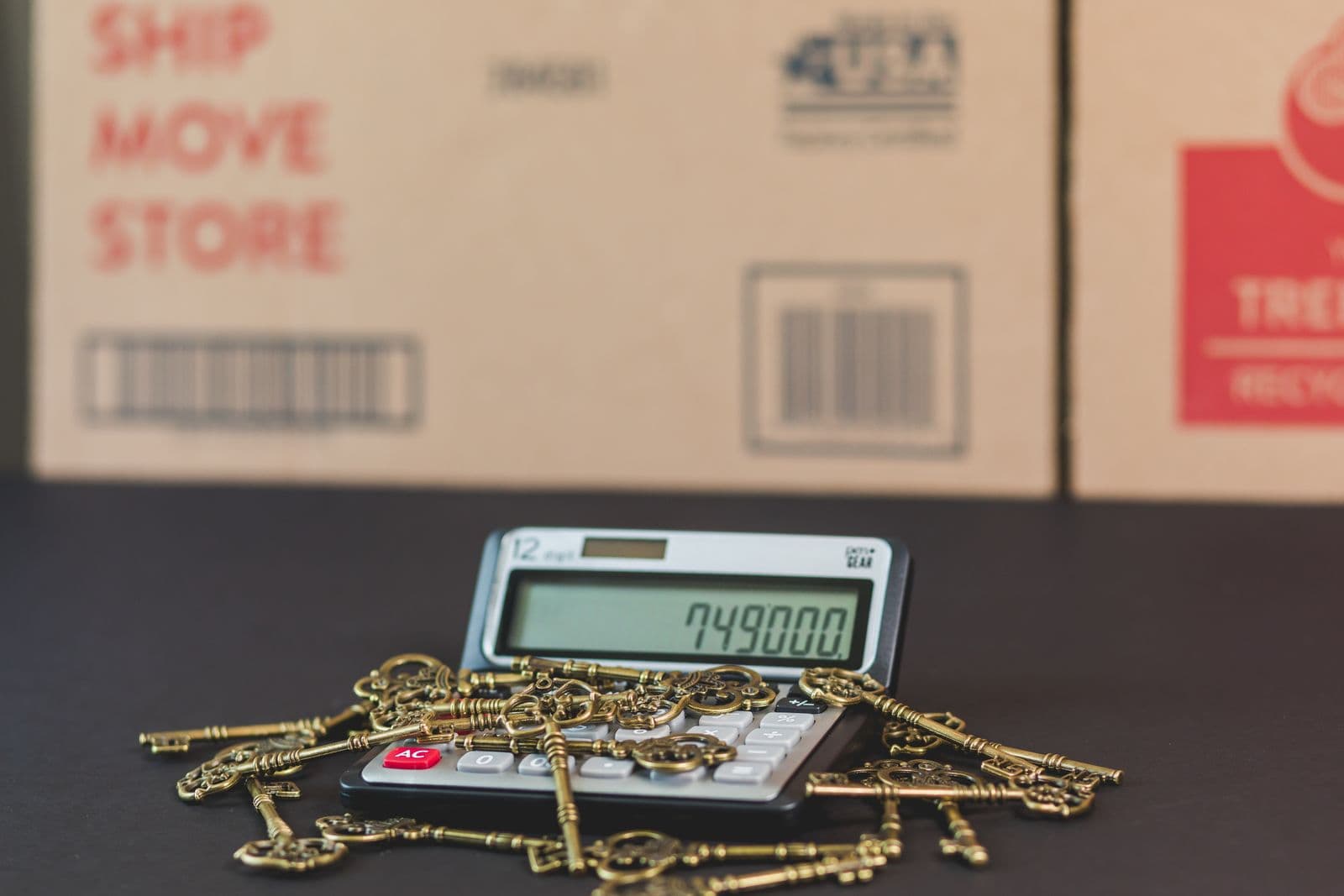 A set of house keys resting on a calculator, representing mortgage rate math