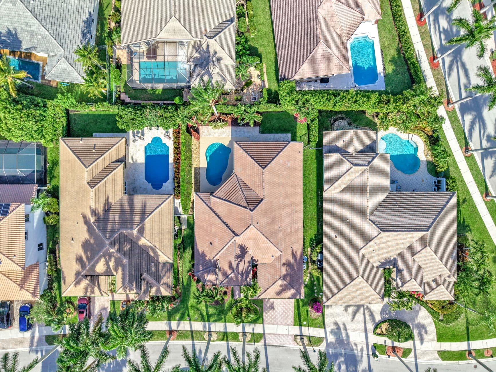 Aerial shot of Miami homes showcasing elegant architecture and private pools.